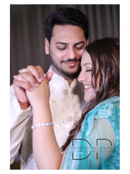 A tender moment captured during a dance, with the couple's happy expressions telling a story of love and excitement.