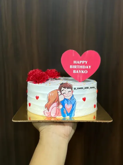 A personalized cake for "Bayko" (wife) with a cute couple illustration and fresh flowers.