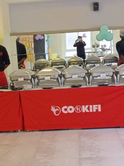 Our team posing behind the buffet line, ready to kick off the food service for a birthday party.