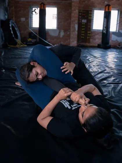 Two of our female fighters demonstrating their skill and dedication on the mats. They are learning valuable grappling techniques while building mental and physical strength.