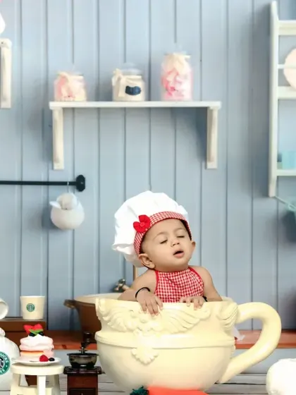 A sleepy little chef takes a break in a giant teacup, a cute and funny moment captured in our kitchen set.