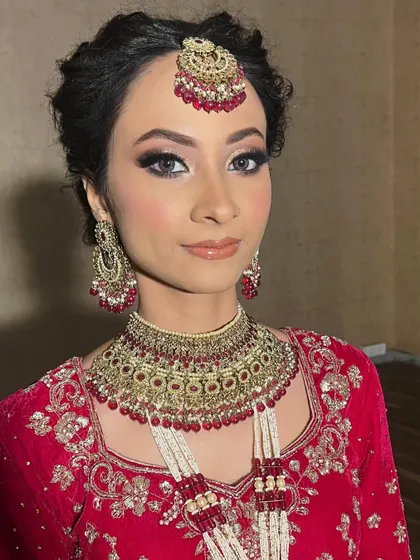 This bride's final look is a picture of perfection. The makeup enhances her features beautifully, ensuring she looks and feels her best on her wedding day.