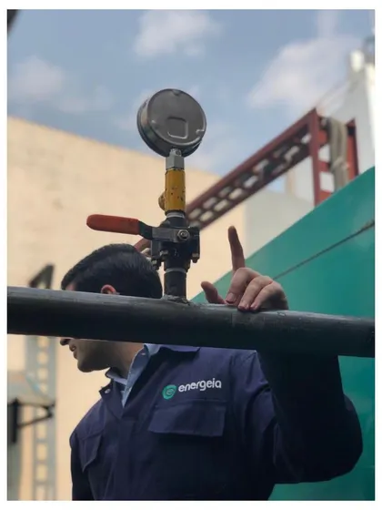 An Energeia engineer inspects a pressure gauge on an industrial pipeline. Our team is trained to get their hands dirty and embrace the challenges of complex industrial environments to deliver results.