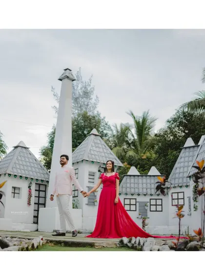 Hand in hand, ready for their forever. The bride's pink trail gown adds a beautiful flow and a pop of color to this charming pre-wedding photo.