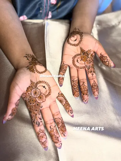 A whimsical and modern design with crescent moon shapes and delicate floral patterns scattered across the palm.