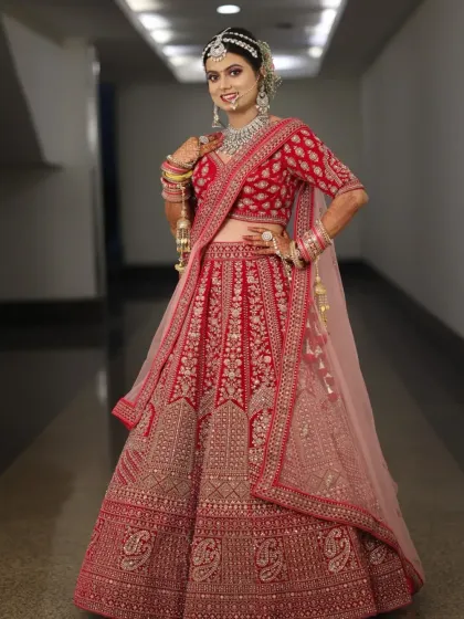 This stunning bride in her red lehenga is a perfect example of a classic North Indian bridal look. We focused on radiant skin, bold eyes, and a traditional bridal bun adorned with flowers.
