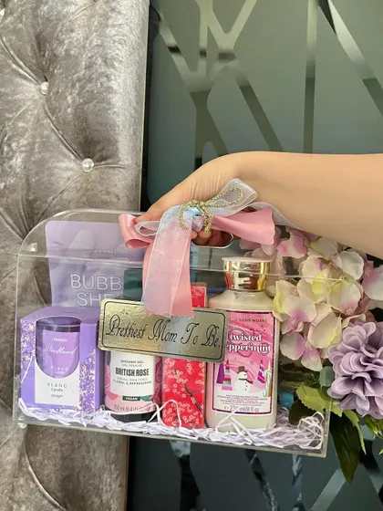 Our luxe acrylic bag hampers are so chic and totally customizable. This one was designed for a special mom-to-be, filled with pampering essentials like lotions, a scented candle, and a bubble sheet mask, all in a pretty purple theme with a custom "Prettiest Mom To Be" tag.