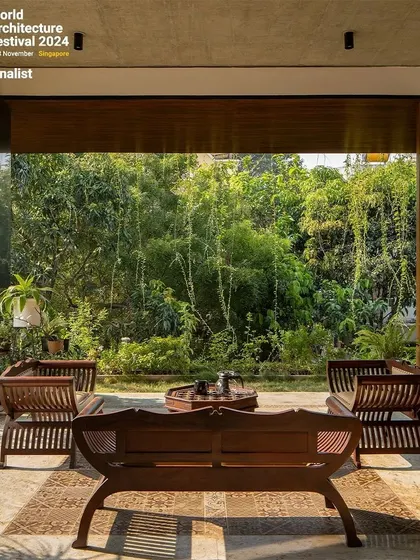 A quiet seating area on the ground floor, designed as a pavilion that opens completely to the dense bamboo grove in the neighboring property. We framed this view to make it a central feature of the home.