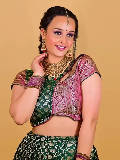 A three-quarter portrait showing the harmony between the makeup, hair, and outfit. The soft smile is enhanced by the chosen lip color and radiant cheek blush.