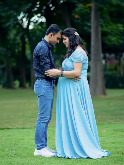 An intimate moment between an expecting couple, captured in a quiet corner of a park. These are the quiet, heartfelt memories we aim to preserve.