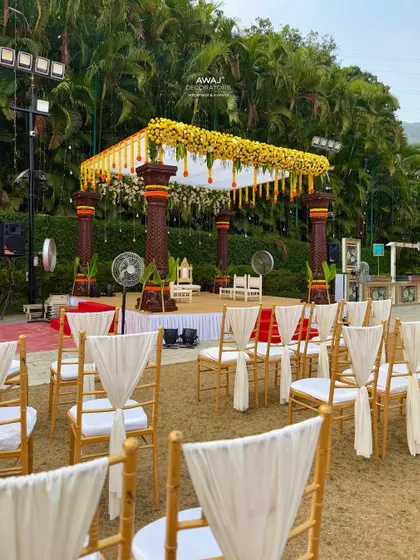A view of the mandap from the guest seating area, showing the beautifully draped chairs and the clear view of the ceremony space.