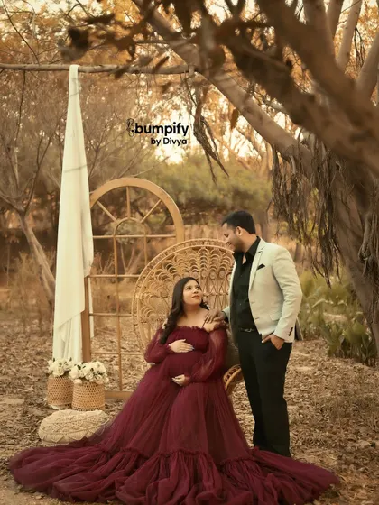 A full view of our outdoor woodland maternity setup, complete with a rustic window frame and a beautiful peacock chair for the glowing mom to be.
