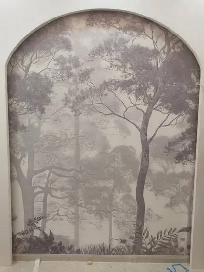A misty forest mural installed within an arched niche. This creates a beautiful, window-like effect, adding depth and a sense of tranquility to the room.