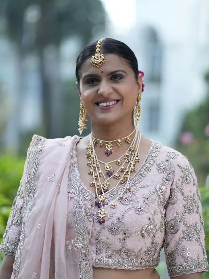 A smiling portrait that shows off her radiant makeup. The soft glam look is perfect for any wedding event, providing a timeless elegance.