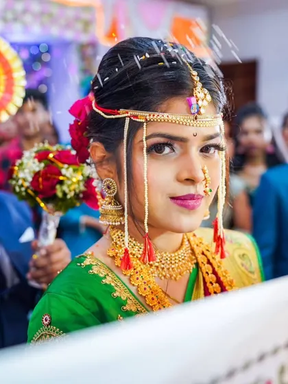 The bride's grand entrance, a significant moment captured with a focus on her traditional green saree and bridal accessories.