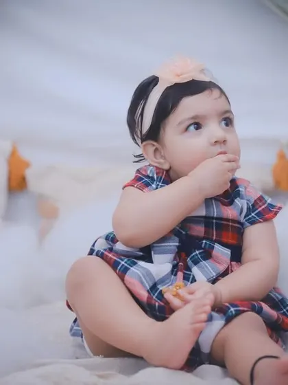 A candid moment of a toddler snacking during her photoshoot. These real-life moments add so much personality to the final gallery.