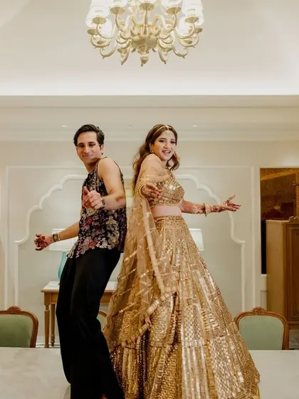 Back to back and ready to party! This fun pose captures the couple's playful dynamic.