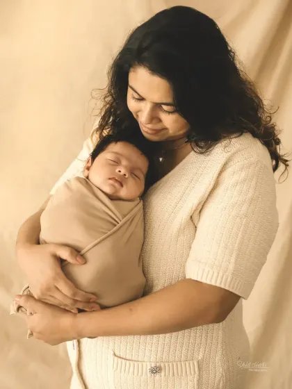 A mother gently cradling her swaddled newborn, a beautiful and serene portrait.