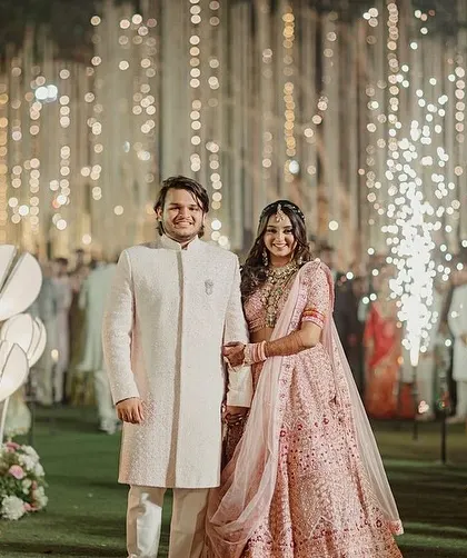 The happy couple making their way down the aisle, surrounded by the warm glow of our custom-designed lamps and the smiles of their loved ones.