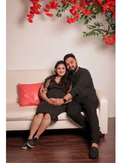 For this shot, the couple used our white sofa and a pop of color from the red floral prop. It shows the versatility of the studio space for creating different moods.