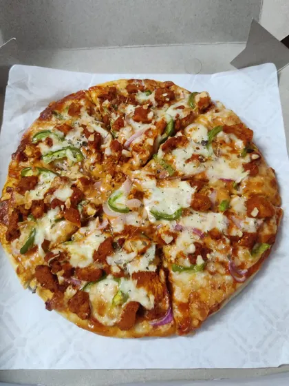 My homemade chicken pizza, made completely from scratch. It features a soft, freshly baked base, my special tangy sauce, and is loaded with chicken, capsicum, onions, and plenty of cheese.
