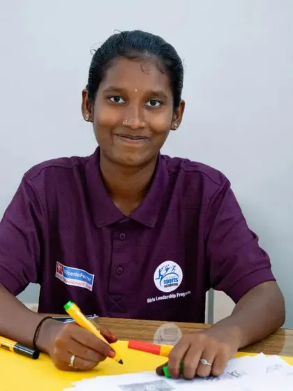 A participant of the Female Athlete Leadership Programme works on a creative assignment. The program uses interactive methods to teach complex topics like financial literacy and careers in sports.