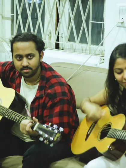 A candid moment of two participants jamming on their guitars. Our workshops are as much about having fun and making friends as they are about learning music.