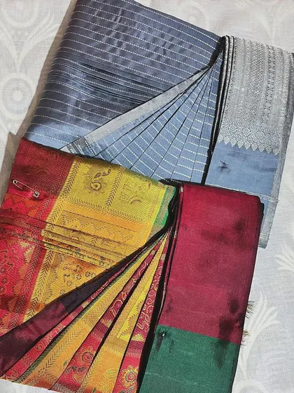 A vibrant multi-colored silk saree and a classic cotton one, both pre-pleated and ready for draping. The pin holds the pleats securely in place until you are ready to wear it.