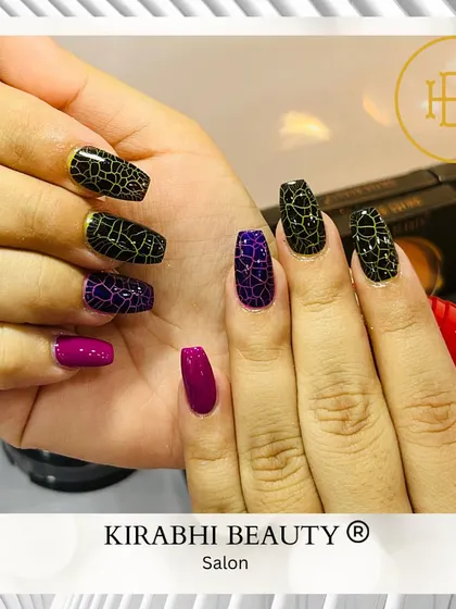 This edgy design uses a special crackle-effect polish in black and purple over a solid base. It creates a unique, textured look that's different every time.