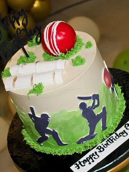 A close-up of the cricket-themed cake, showing the detailed edible decorations for a young cricket lover.