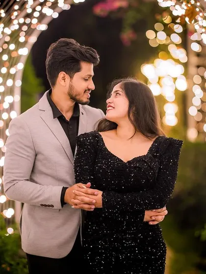 A classic romantic pose under an arch of fairy lights. This is the kind of magical moment I love helping couples create with the right outfits for their pre-wedding shoot.