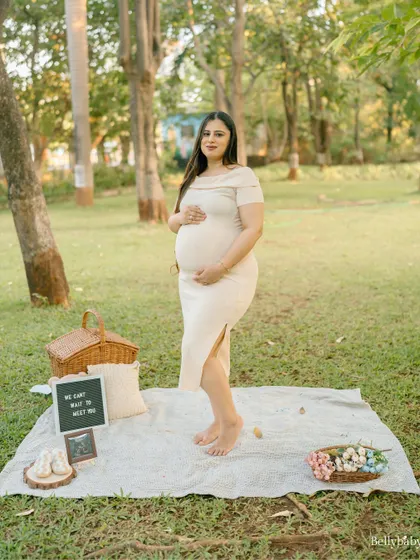 A lovely solo portrait from a park picnic session. The setup with the letter board and basket adds a sweet, personal touch.