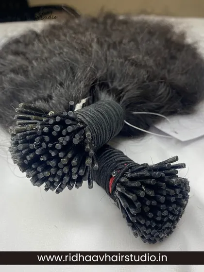 This image shows bundles of our I-Tip Single Drawn Raw Curly Hair Extensions. The raw texture provides a very natural and voluminous curly look that blends perfectly with similar hair types.