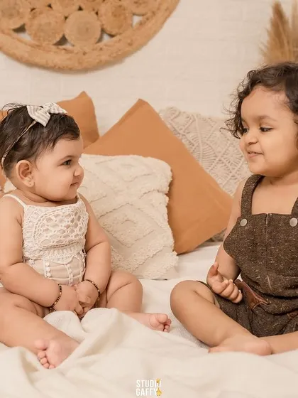 Double the trouble, twice the fun! Two little ones sharing a moment in our studio.