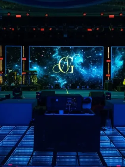 The stage featured a massive LED screen displaying a custom monogram against a galactic nebula. Paired with an infinity-mirror dance floor, the setup provided a dynamic and visually stunning focal point for the night's performances.