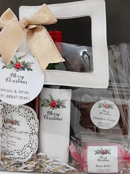 Our custom 'Merry Christmas' stickers and tags adding a professional touch to a festive gift bag from Whisks & Whirls.