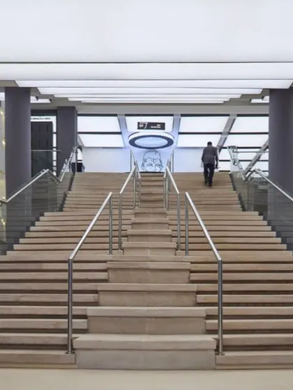 Another view of the grand interior staircase, showcasing the scale and modern aesthetic of the museum's public spaces.
