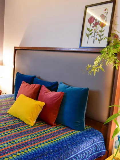 A close-up of the vibrant cushions on the bed. They add a pop of color and cheerfulness to the room.