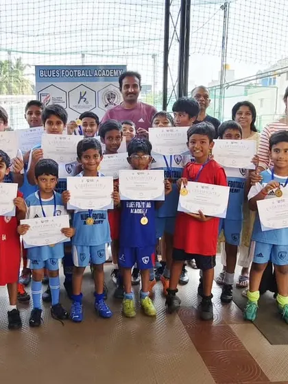 A proud group of young players holding their certificates and medals after a tournament. This photo perfectly illustrates my philosophy of recognizing every participant.