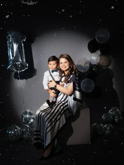 A glamorous mother and son portrait in a disco-themed setup. Including parents in the fun creates stylish and memorable photos.