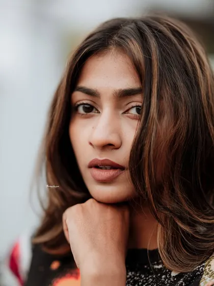 A close-up portrait that feels intimate and powerful. The focus is entirely on the model's expression and striking features.