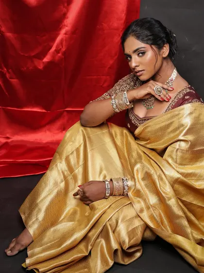 A full-length shot that captures the grace and beauty of the model. This is a perfect example of how to style and shoot makeup on deep skin tones.