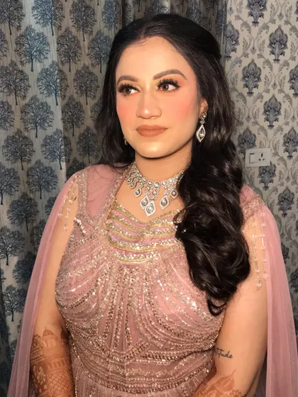 A portrait of the reception bride, showing her soft glam makeup with glittery eyes and a nude lip.