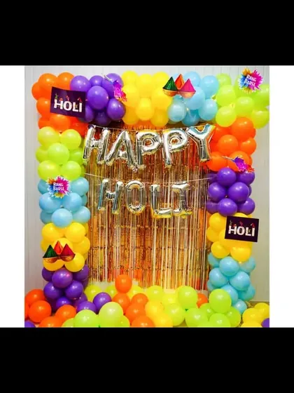 I can create decorations for any festival, like this colorful setup for a Holi party. It features a vibrant balloon frame around a gold fringe curtain and 'Happy Holi' foil letters.