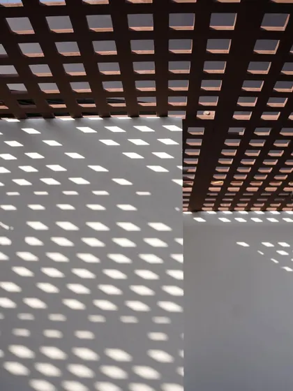 The play of light and shadow created by the wooden lattice ceiling. This architectural detail was a key part of the design, adding texture and visual interest to the space throughout the day.
