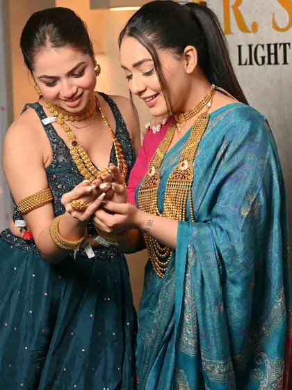 A candid moment between two models during a jewellery shoot. This image tells a story of friendship and shared admiration for the beautiful designs.