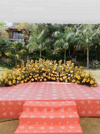 A cheerful Haldi stage decorated with a carpet of sunflowers and marigolds, creating a perfect backdrop for the ceremony.