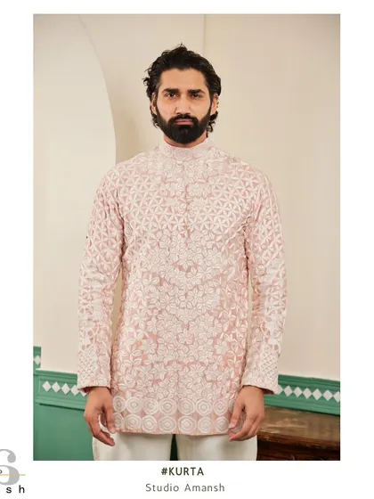 Our blush pink kurta, featuring a stunning geometric floral pattern in all-over white hand-embroidery.
