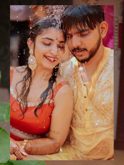 A close-up shot of the couple during the water-showering ritual of their Haldi, focusing on their happy and intimate expressions.