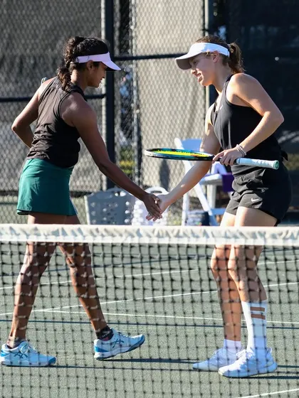 A handshake at the net concludes a competitive match, embodying the respect and sportsmanship we value.